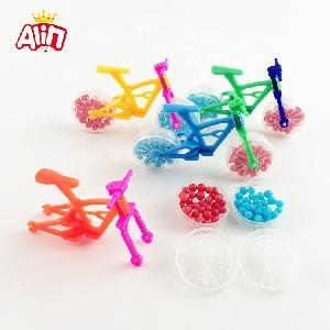 Brightly colored toy bicycle with two transparent wheel full mini round shaped hard candy