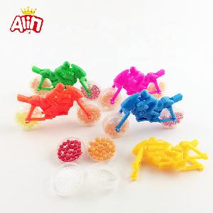 Brightly colored toy motorbike and whistle with two transparent wheel full mini round shaped hard candy
